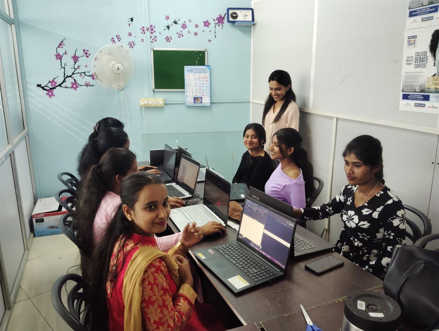 Interns working on laptops at the Mitra Softwares office