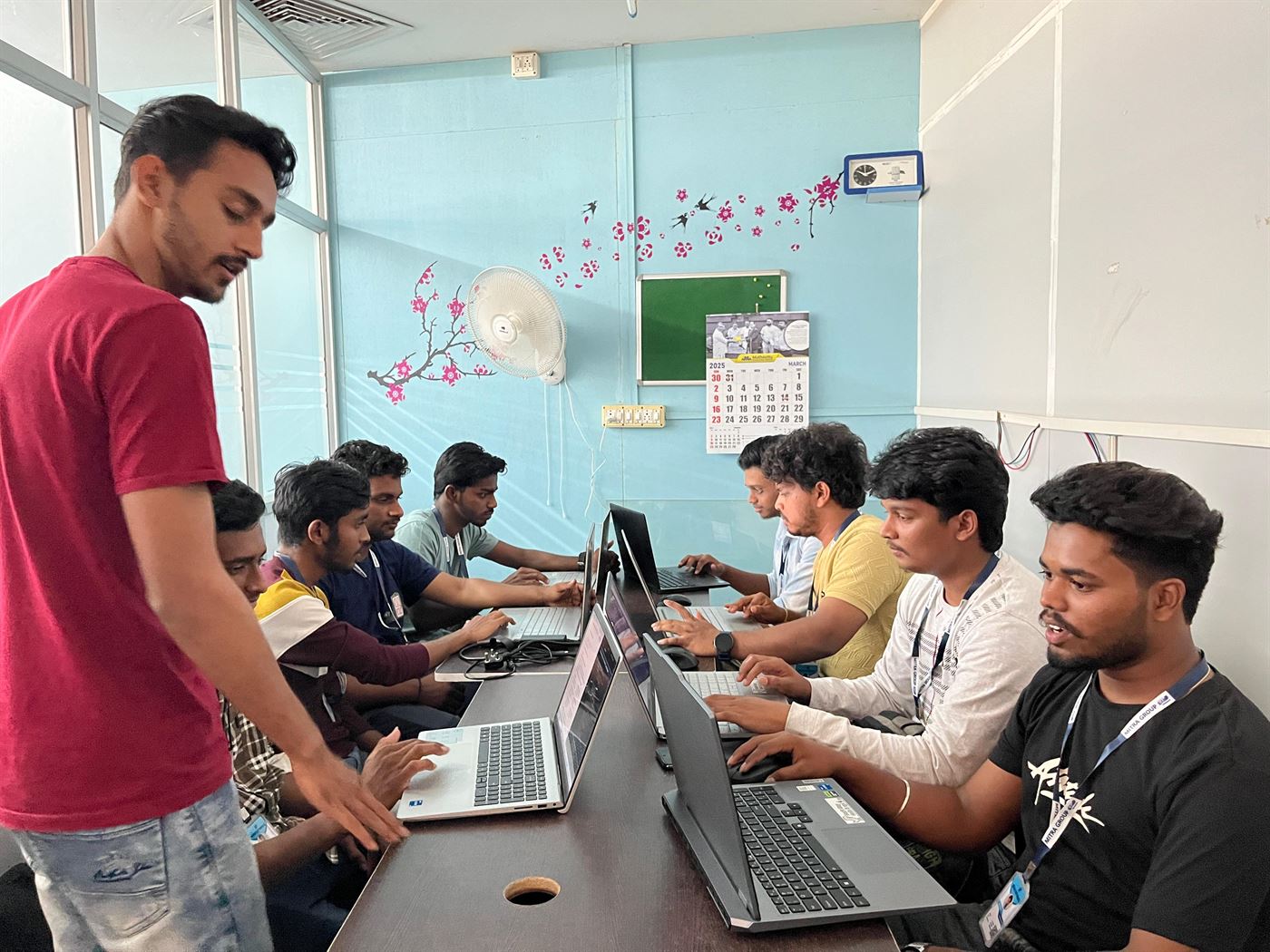 A Mitra Softwares mentor reviewing work with developers