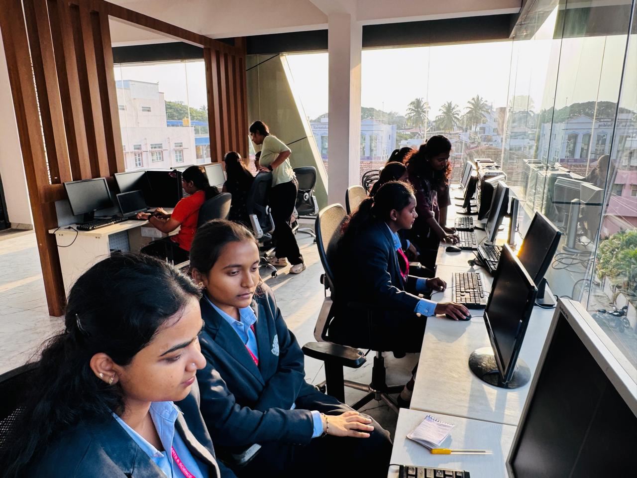 Interns at desks by the window